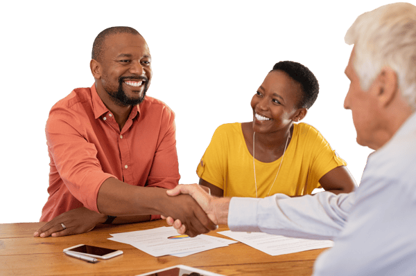 Two people shaking hands over a table Two people shaking hands over a table