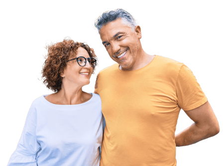An older man and woman stand together smiling An older man and woman stand together smiling