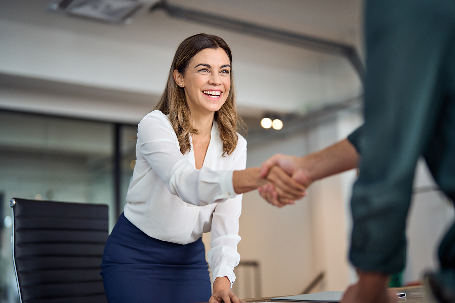 A businesswoman shakes someone's hand