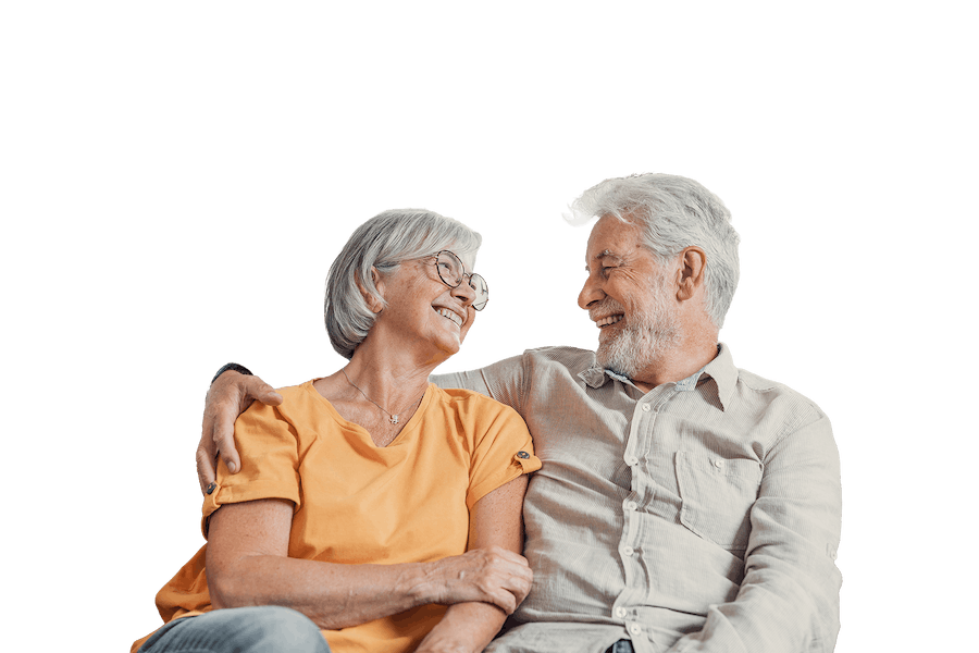 An elderly couple looking caringly at each other